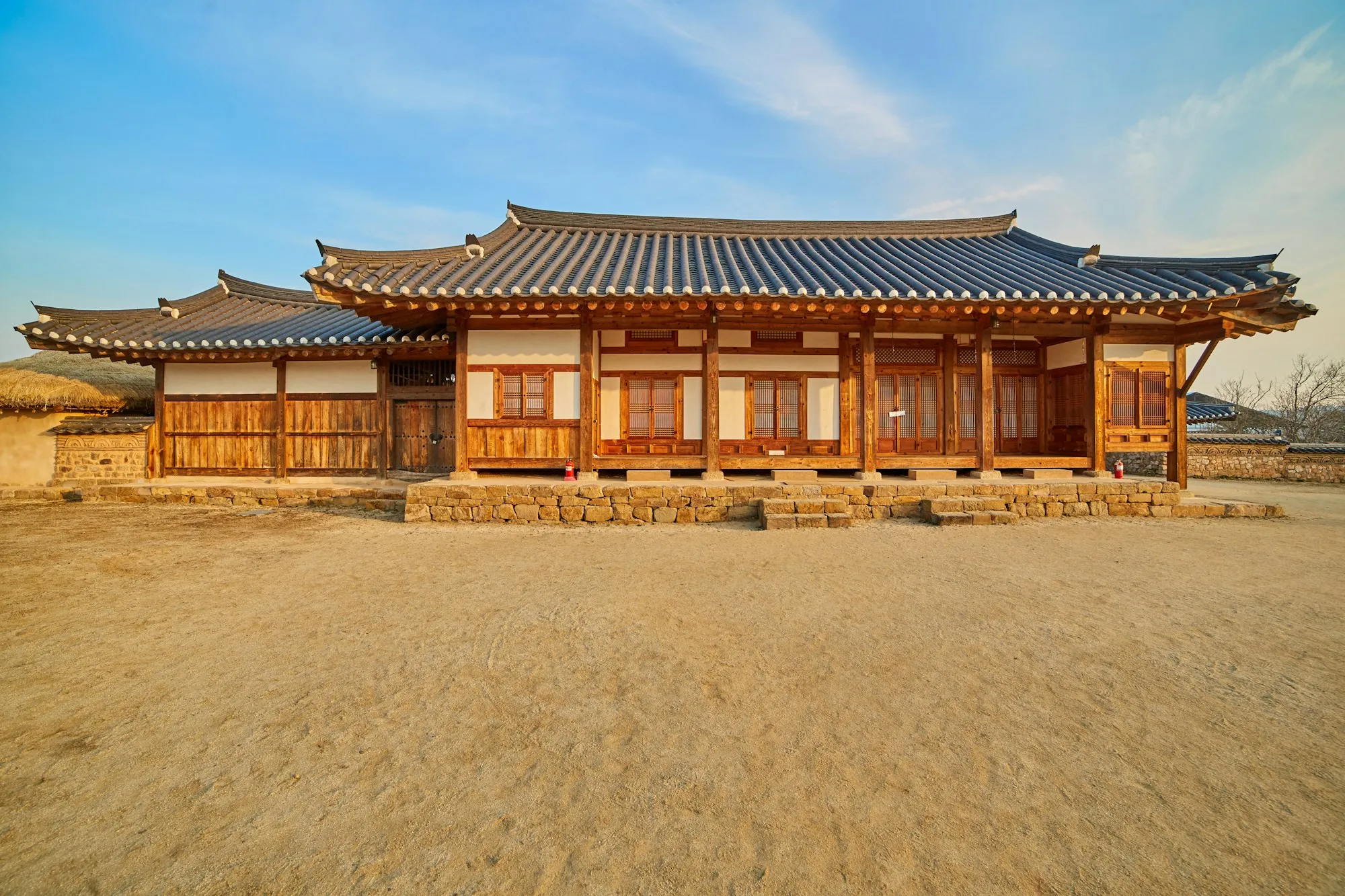 A single-storey traditional wooden house with a tiled roof
